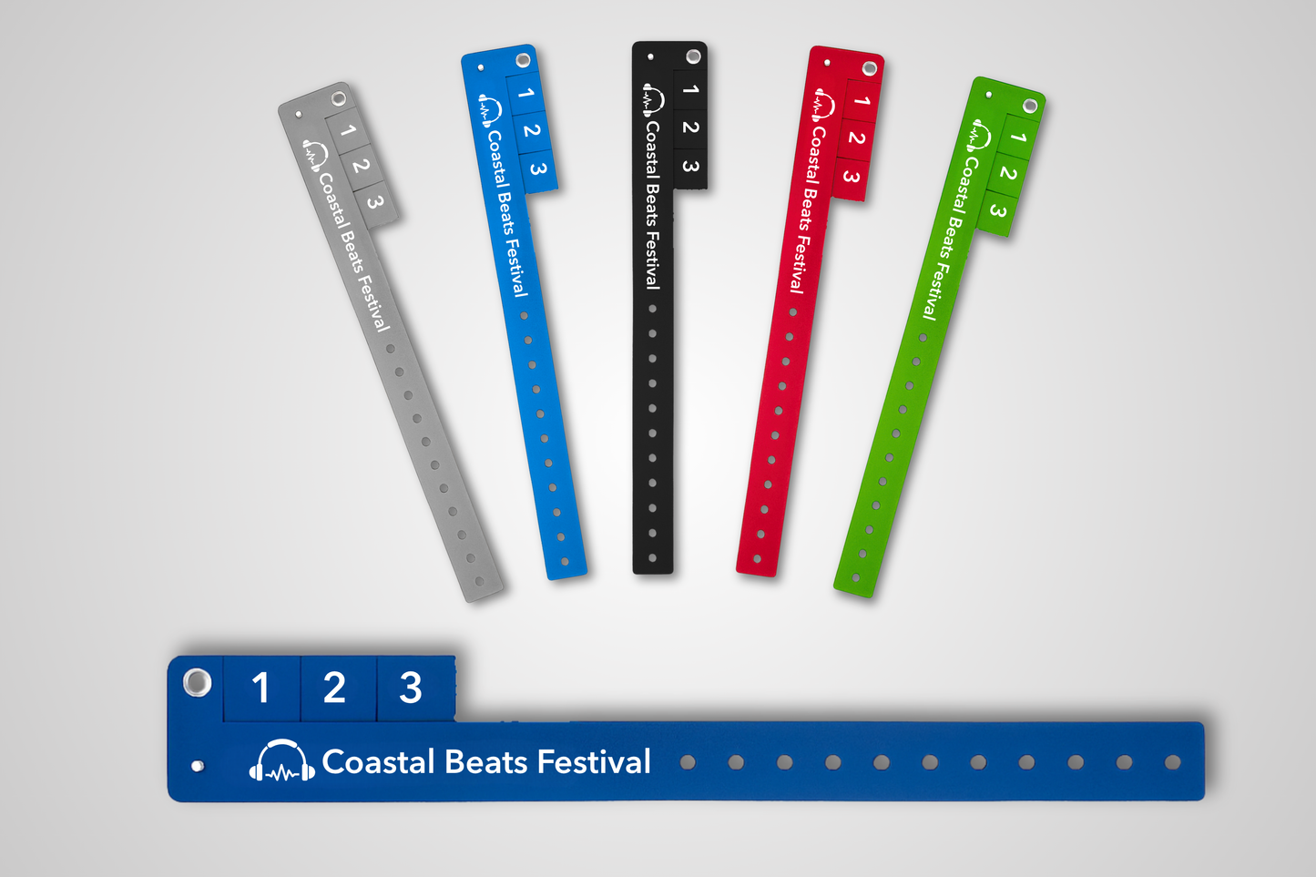 A photo of entry wristbands with detachable tickets in different colors