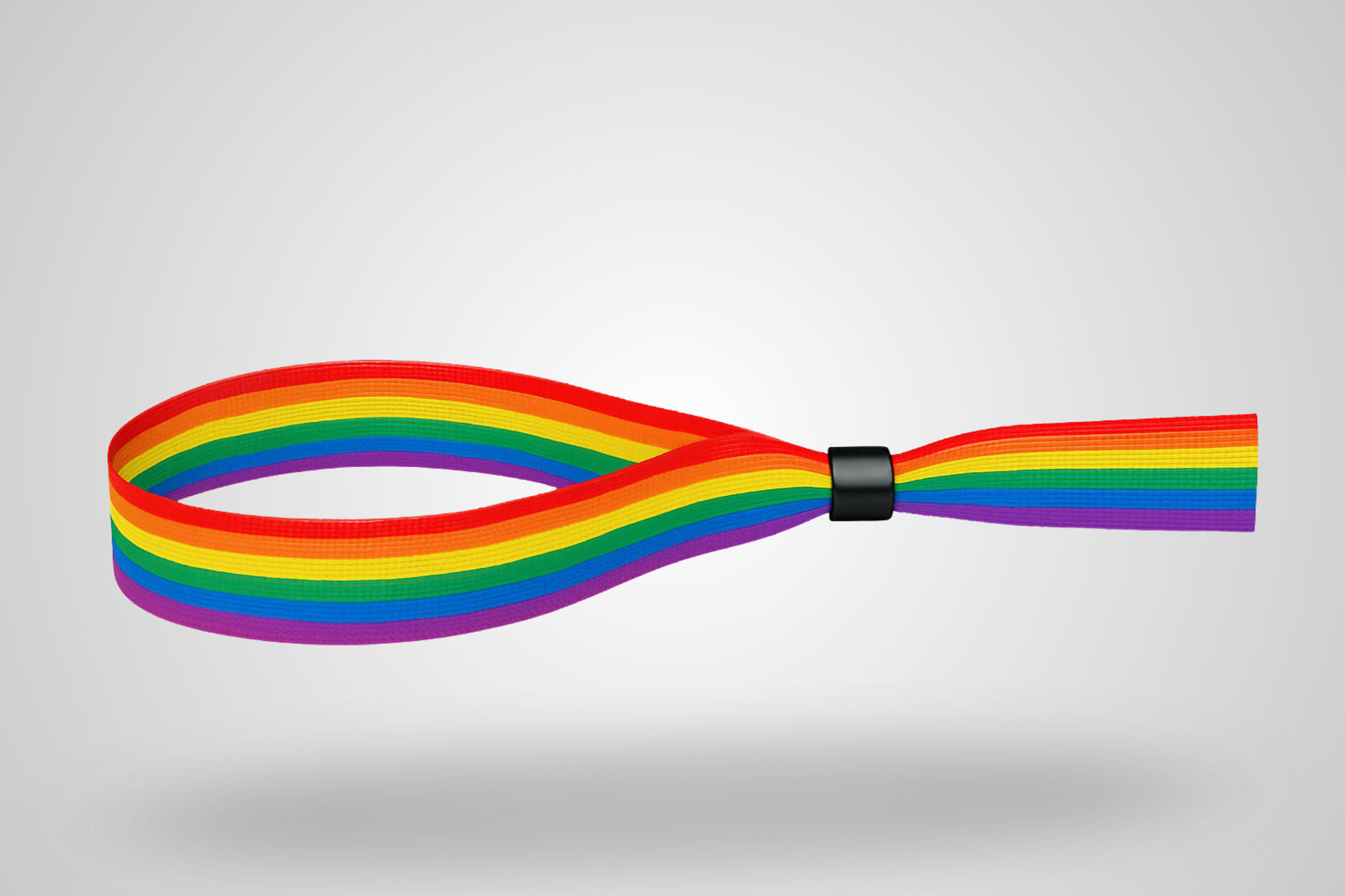 A photo of a fabric wristband with pride rainbow color pattern