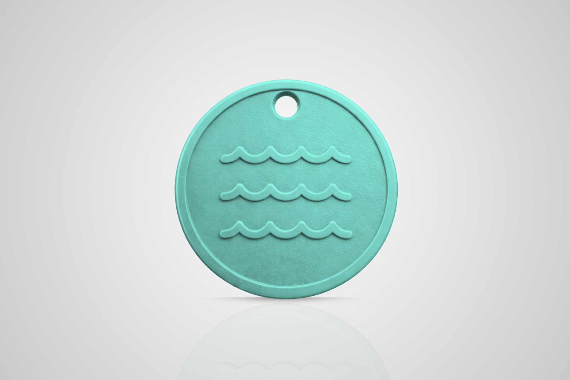 Ocean plastic token in turquoise with a motif of waves from JMband®