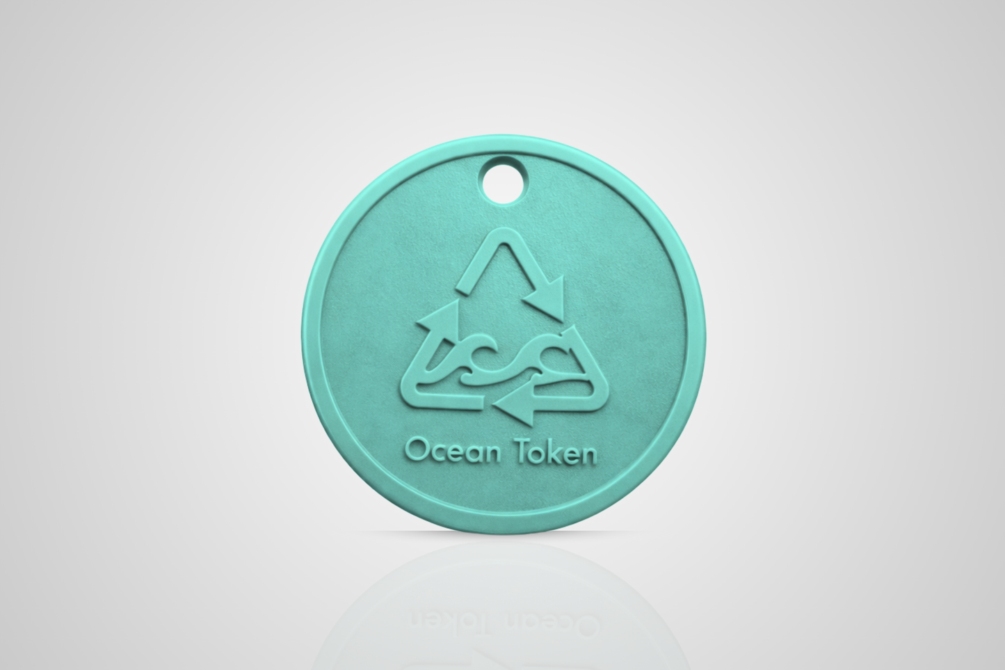 Ocean plastic token in turquoise with a motif of a recycle symbol with waves and the text "Ocean token" from JMband®